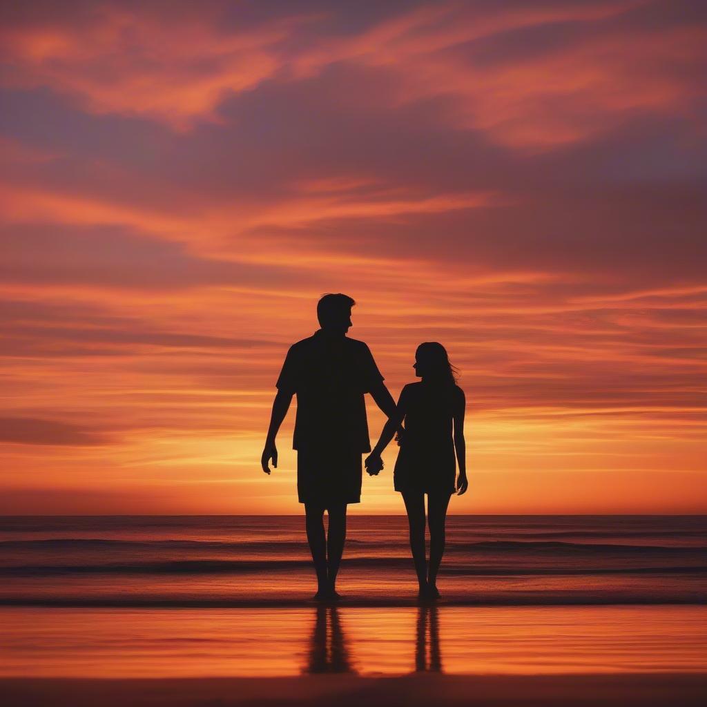 Couple Holding Hands at Sunset on the Beach