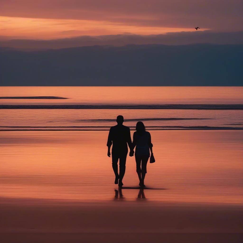 Couple holding hands on a beach at sunset, symbolizing lasting love.