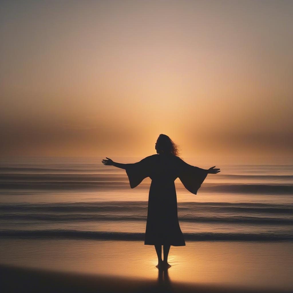 A woman stands alone on a beach, arms outstretched, embracing the solitude and finding strength within herself.